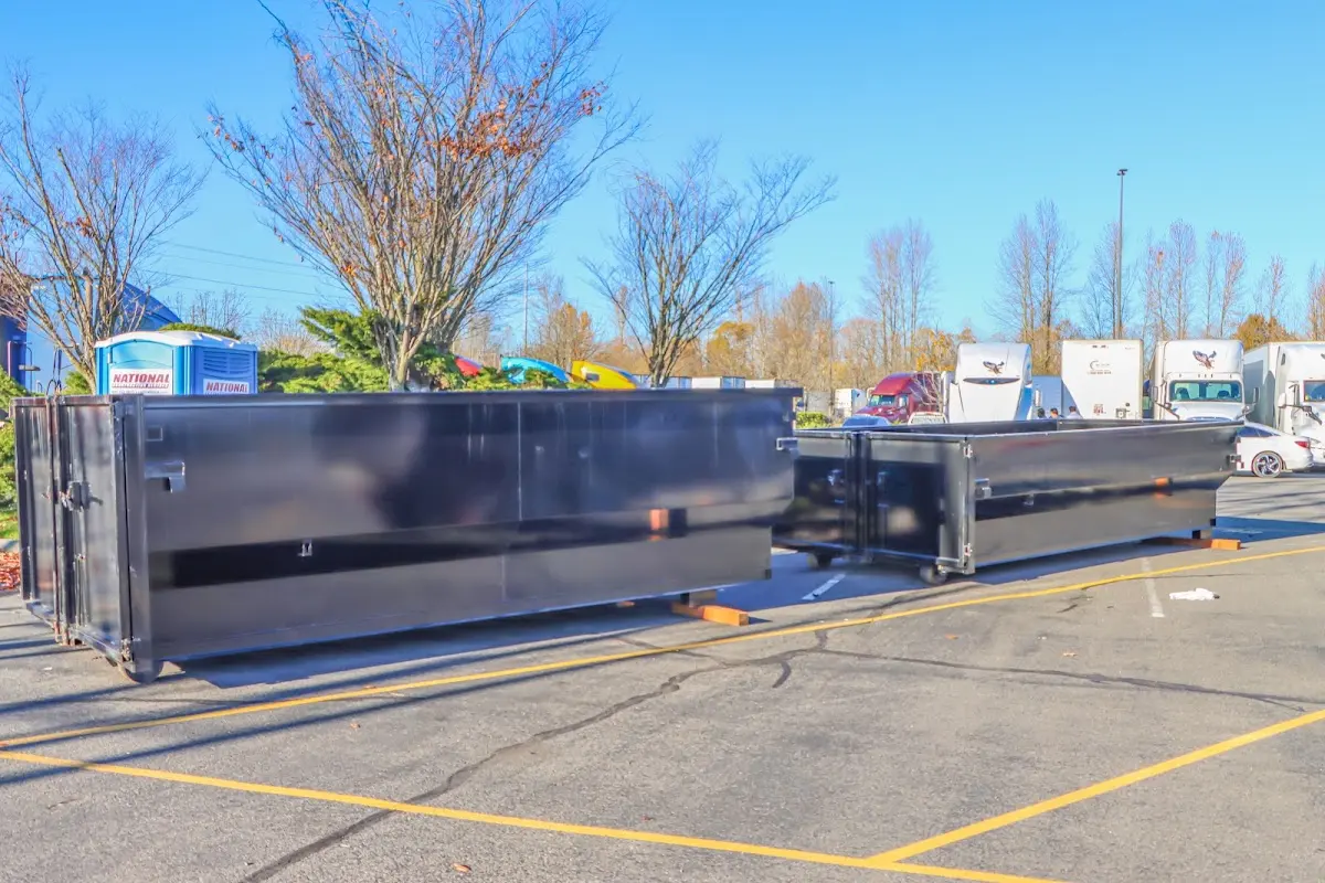 Professional dumpster rental service with roll-off container on residential driveway in East Foothills